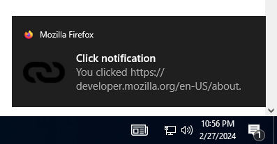 Example notification on Windows 10, located above the system clock, with a bold title reading "Click notification" followed by regular text reading "You clicked https://mdn.org.cn/en-US/docs/MDN". The notification has a small Firefox logo in the top left corner that is followed by "Mozilla Firefox", and a link icon to the left of the primary notification text.